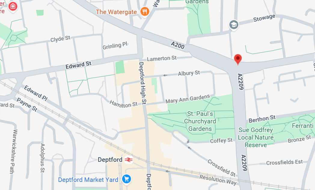 A beautiful walking path through a lush city park with a skyline in the distance.